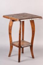 AN AESTHETIC MOVEMENT POLISHED BEECH OCCASIONAL TABLE, in the Liberty style, all-over carved with