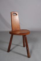 THOMPSON OF KILBURN 'MOUSEMAN', an oak spinning chair the tapered back with finger grip, on three