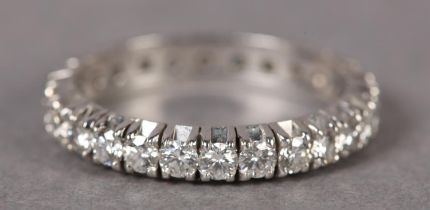 A DIAMOND ETERNITY RING, c1960, the brilliant cut stones claw set in line in platinum, finger size