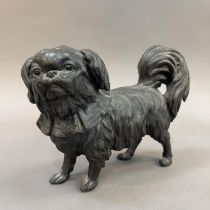 A 19TH CENTURY PEWTER FIGURE OF A PEKINGESE DOG, 20cm long x 16cm high (Shipping category D)