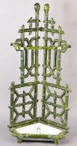 AN AESTHETIC MOVEMENT CERAMIC STICK STAND, cast as bamboo, in pale green glaze with drip tray to