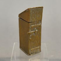 A VICTORIAN BRASS NOVELTY VESTA, in the form of a wooden privy with gentleman seated 4.75cm high x