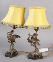 A PAIR OF EPNS TABLE LAMPS IN THE FORM OF A CRANE PERCHED ON THE BACK OF A TURTLE, on black marble