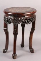 A 19TH CENTURY CHINESE HARDWOOD AND MARBLE INSET URN STAND OF OVAL OUTLINE, the apron pierced and