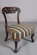 A VICTORIAN MAHOGANY NURSING CHAIR, with pierced foliate carved open back, upholstered seat, on