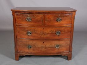 A GEORGE III MAHOGANY BOWFRONT CHEST of two short and two long cockbeaded drawers, brass oval back
