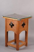 AN ARTS & CRAFTS OAK OCCASIONAL TABLE of square outline, the surface carved in relief with plant
