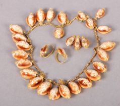 A MID 19TH CENTURY COWRIE SHELL DEMI PARURE IN HIGH CARAT GOLD, consisting of fringe necklace,
