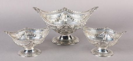 A SET OF THREE LATE VICTORIAN SWEETMEAT BASKETS, London 1898/9, of boat-shape with twin leaf and