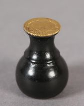 AN EBONY SEAL WITH A GEORGE III ONE-THIRD GUINEA MATRIX (the coin c1797-1813), 3cm high (Shipping