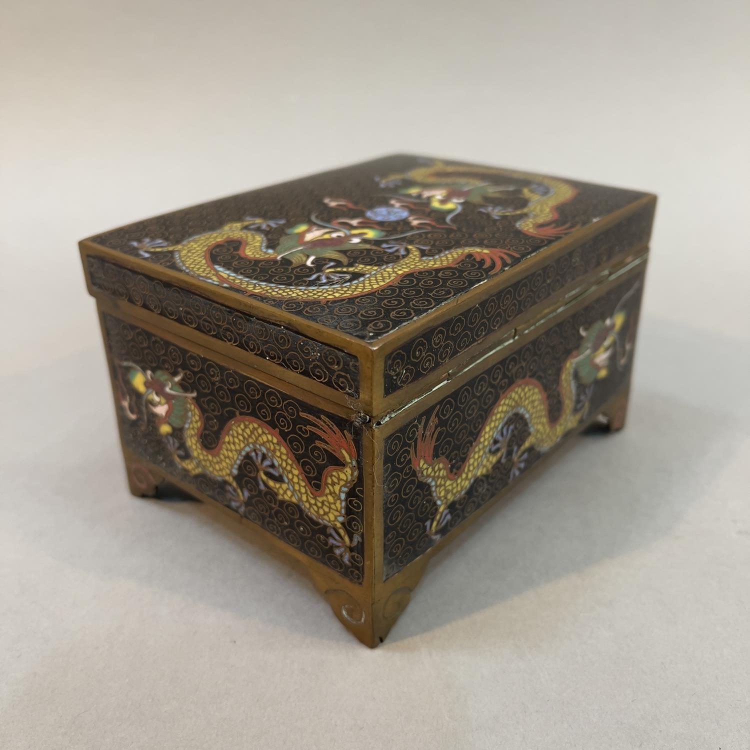 A CHINESE CLOISONNE CASKET, rectangular, the black ground with opposing dragons chasing the - Image 2 of 3
