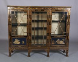 AN EBONISED AND GILT CHINOISERIE BREAKFRONT BOOKCASE CABINET, the top gilded with island vignette