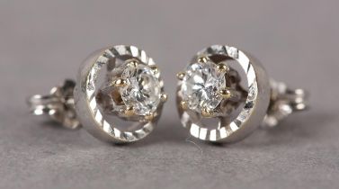 DIAMOND STUD EARRINGS, c1970, each claw set to the centre with a brilliant cut diamond raised