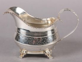 A GEORGE III SILVER HELMET CREAM JUG, London 1817 for Naphtali Hart, engraved with a crest to