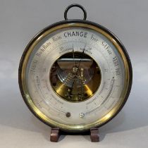 AN EARLY 20TH CENTURY ANEROID BAROMETER-THERMOMETER in lacquered brass case with pendant loop, 20.