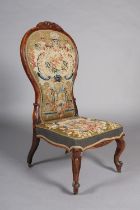 A VICTORIAN ROSEWOOD PRIE DIEU CHAIR, having an encircling frame with flower and leaf cresting,