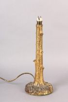 AN EARLY 20TH CENTURY GILT METAL TABLE LAMP CAST AS A TREE, 36 cm high to fitting (Shipping category