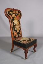 A VICTORIAN WALNUT PRIE DIEU CHAIR, having an encircling frame with foliate cresting, original