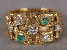 AN EMERALD AND DIAMOND RING C1960, the circular faceted emeralds (at fault) and brilliant cut