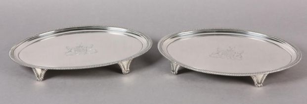 A PAIR OF LATE GEORGE III SILVER SALVERS, London 1806 for John Mewburn of oval outline with