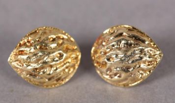 A PAIR OF EAR STUDS IN 18CT GOLD each fashioned as an almond nut in half relief, approximately