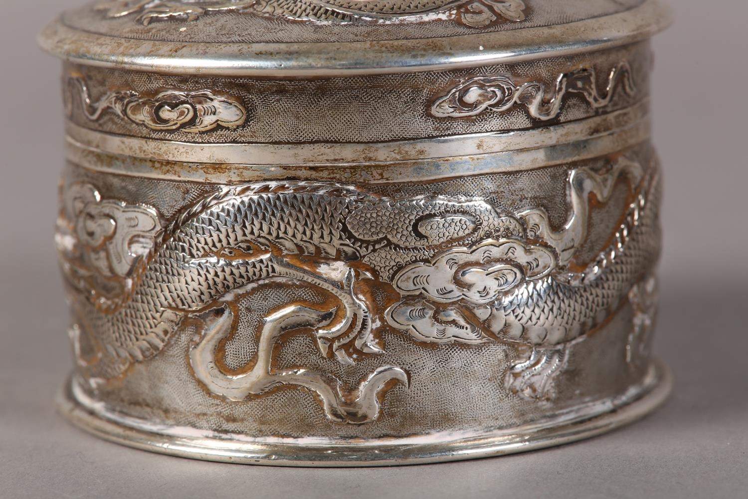 A CHINESE SILVER BOX AND COVER, cylindrical, embossed with dragons chasing the flaming pearl on a - Image 4 of 8