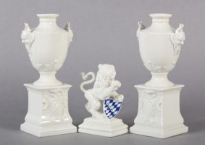 A PAIR OF LATE 19TH CENTURY NYMPHENBURG WHITE PORCELAIN VASES RAISED ON INTEGRAL PLINTHS, 15.5cm