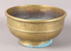 A CHINESE BRASS BOWL, the annulated body engraved with reserves of peony and diaper cell on foot