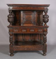 A 17TH CENTURY JOINED OAK COURT CUPBOARD, having a foliate carved cornice, the frieze inlaid in