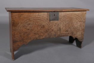 A MID 17TH CENTURY OAK BOARDED CHEST, the single plank top over the carved front, incised demi-
