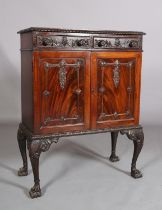 A MAHOGANY CABINET, c1900, having a gadroon rim above two drawers with applied foliate scroll work