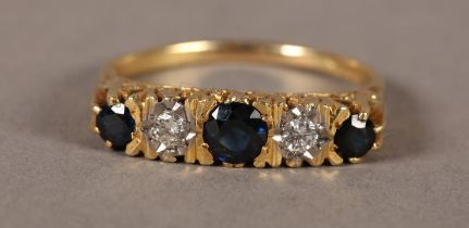 A SAPPHIRE AND DIAMOND FIVE STONE RING in 18ct gold, the graduated circular faceted sapphires claw
