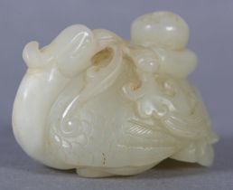 A CHINESE JADE CARVING OF A BOY CLIMBING UPON THE BACK OF A PHOENIX with its head turned backwards