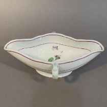 AN 18TH CENTURY ROYAL VIENNA PORCELAIN DOUBLE LIPPED SAUCEBOAT WITH LOOP HANDLES, painted in puce