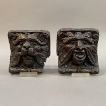 A PAIR OF 18TH CENTURY OAK ANGLE BRACKETS CARVED AS A LION FACE MASK AND GREEN MAN FACE MASK, each