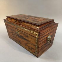 A COROMANDEL WOOD AND BRASS INLAID TEA CADDY, early 19th century, of sarcophagus form with lion mask