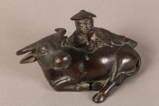 A 19TH CENTURY CHINESE BRONZE GROUP OF A BOY LYING ON THE BACK OF A RECUMBENT WATER BUFFALO, 11cm