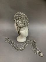 A diamante Folies Bergere head-dress and a six rope body adornment pendant from a circular boss Some