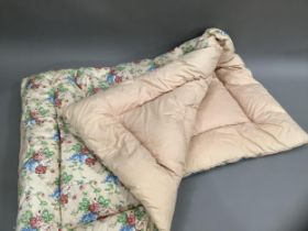 A vintage feather eiderdown in blue, red, green and pink floral printed cotton, 154cm x 106cm
