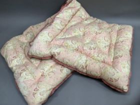 A pair of vintage feather eiderdowns in pale pink, yellow and red paisley printed cotton, 150cm x