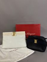 Salvatore Ferragamo: A white leather clutch, having gold metal hardware, monogrammed lining and