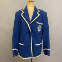 A vintage navy blue wool boy's school blazer with silver ribbon trim