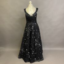 Murray Arbeid: A black silk strappy evening gown covered in graduated silver stars, with a low