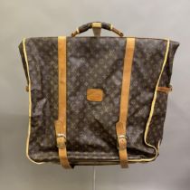 Louis Vuitton: A vintage monogram suit carrier, brown canvas interior with brown leather strap,