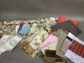 Two boxes of various fabric remnants and trimmings, net curtaining, a small quantity of haberdashery