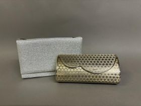 A hard shell gold metal clutch bag, with silver metal edging, lined with blue felt the lid having