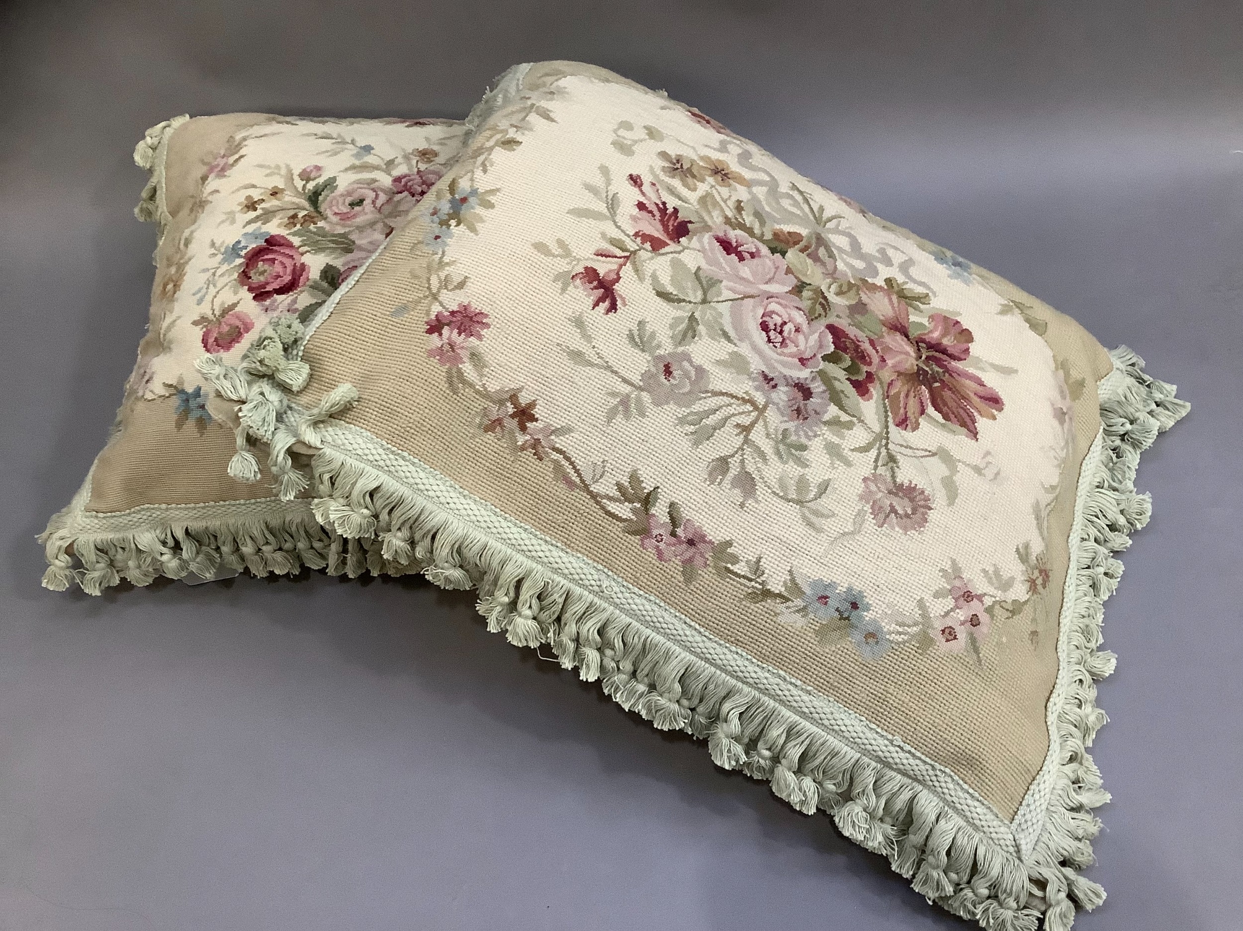 Two Chelsea Textile petit and gros point cushions, ribbon-tied summer flowers in shades of pink