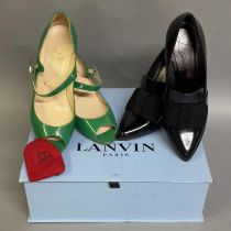 A pair of patent leather very high heeled shoes by Lanvin, having a pointed toe with fabric bow,