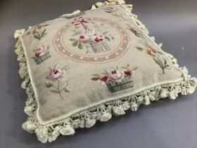 A Chelsea Textile petit and gros point cushion, ribbon-hung basket of blooms within a circle and