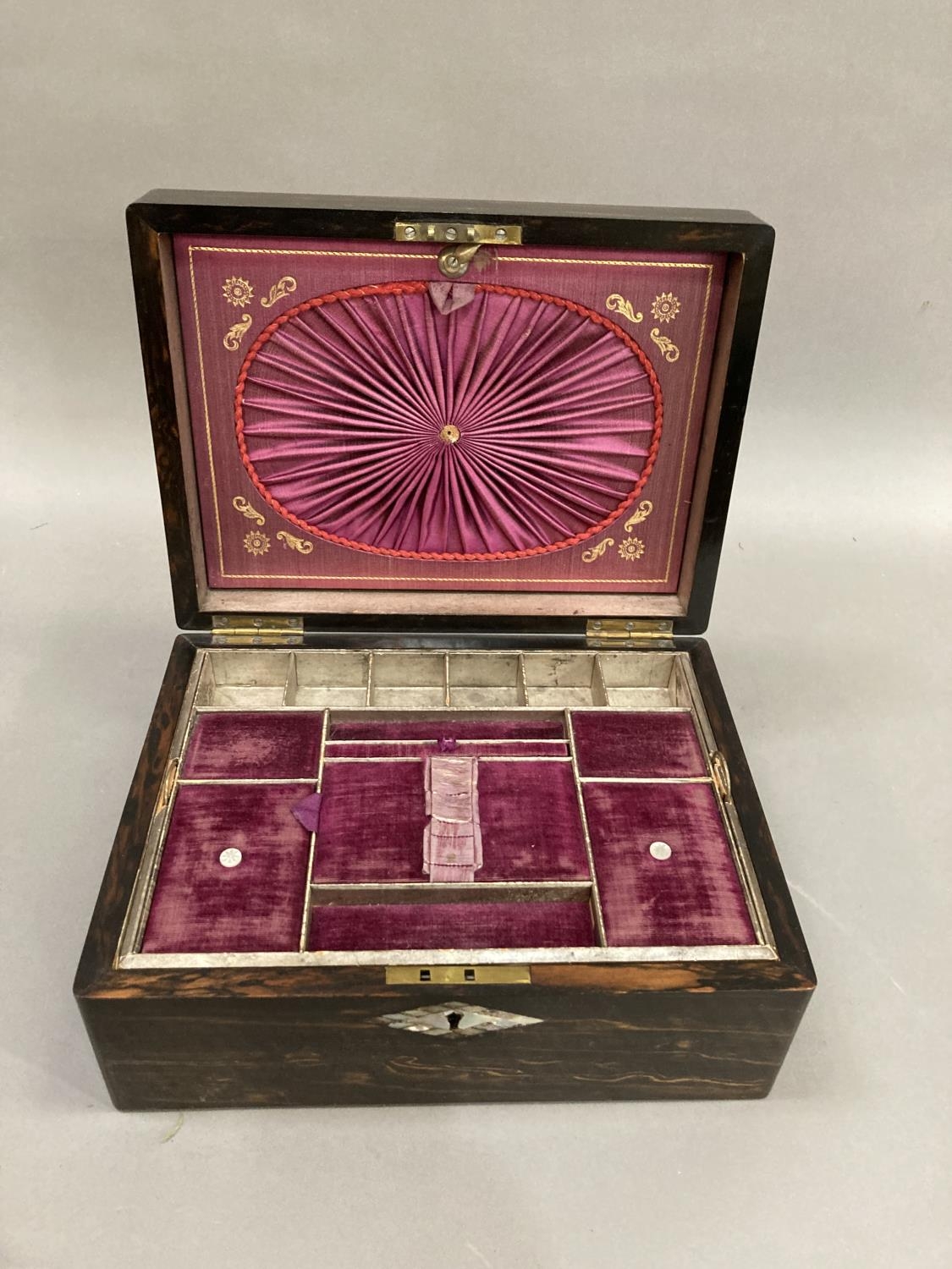 A 19th century coromandel work box inlaid with abalone cartouche and escutcheon, the interior